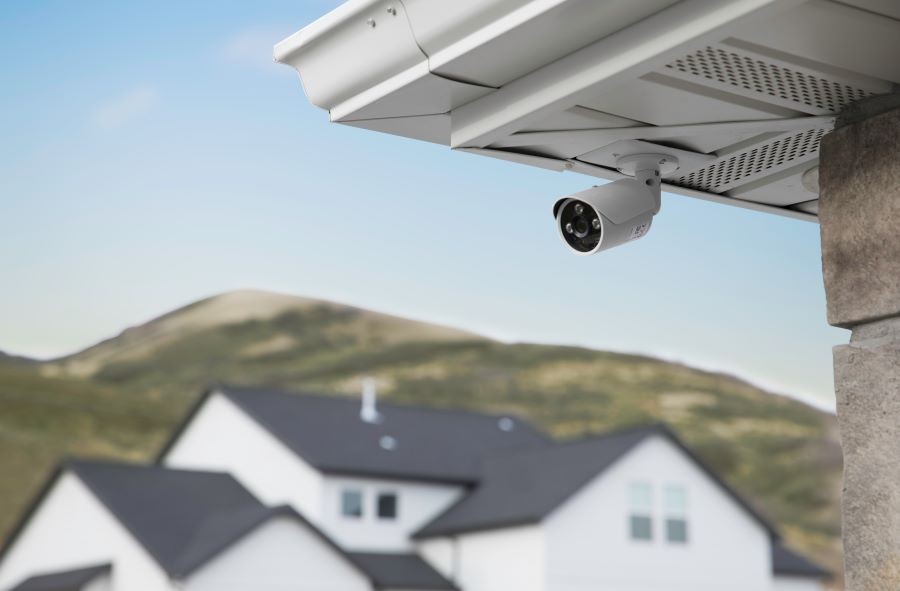 A security camera installed under the eaves of a home.