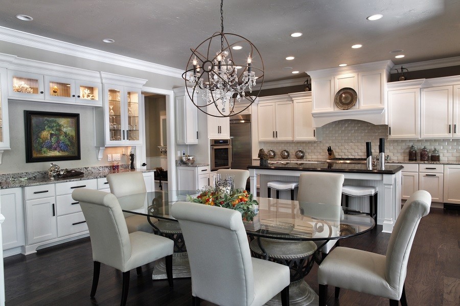 An elegant and sophisticated kitchen with a brilliantly illuminated dining area. 