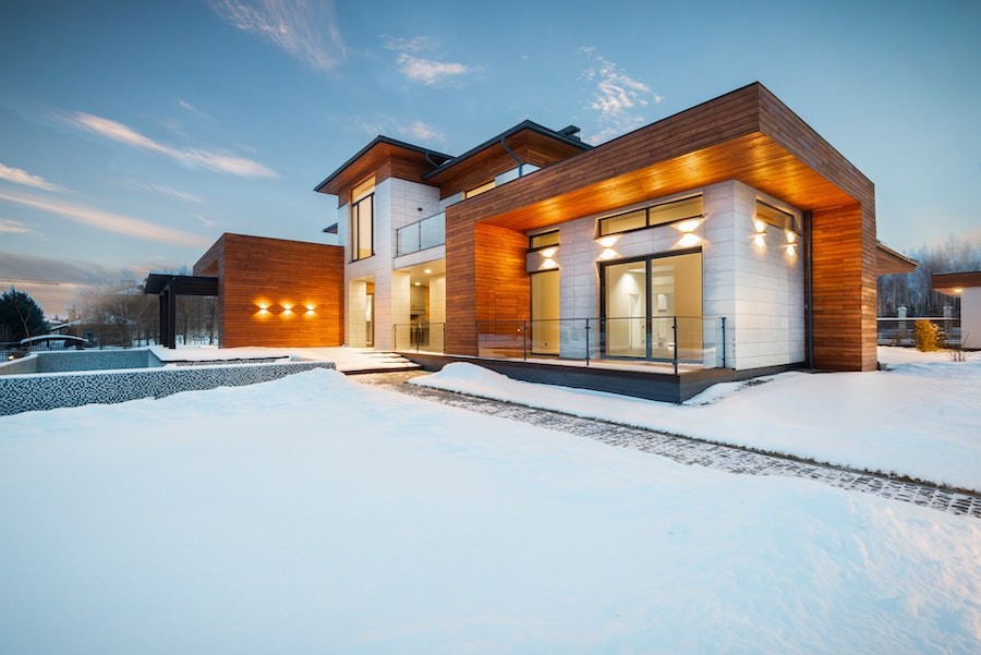 The outside of a modern Utah home in winter with snow on the ground.