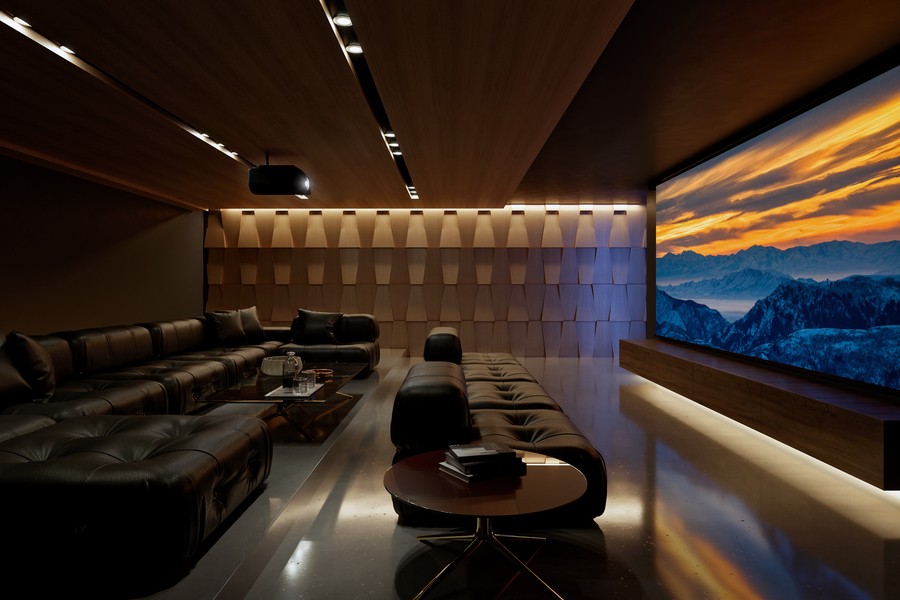 A home theater with a Sony projector, large movie screen, sectionals, and acoustic paneling.