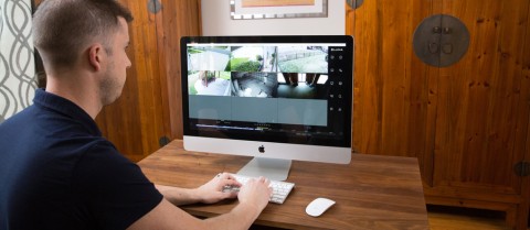 A man monitors his video surveillance system on a computer in a Utah home. 