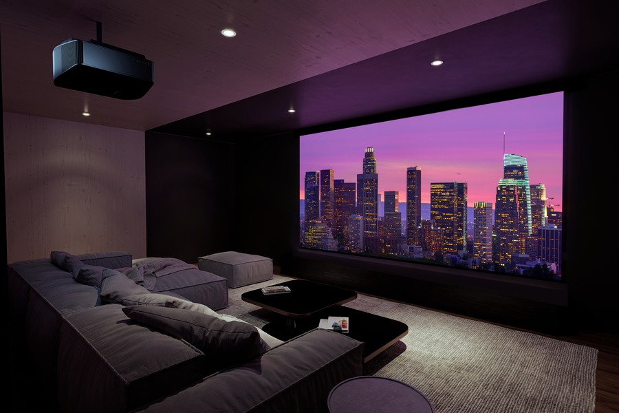 A custom-designed home theater in a Utah home with a projector, large screen, and plush sofa seating. 