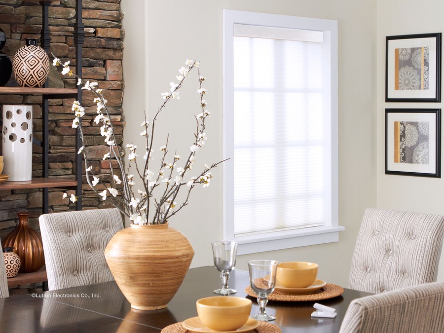 A window with white automated shades in the dining area of a Salt Lake City home. 