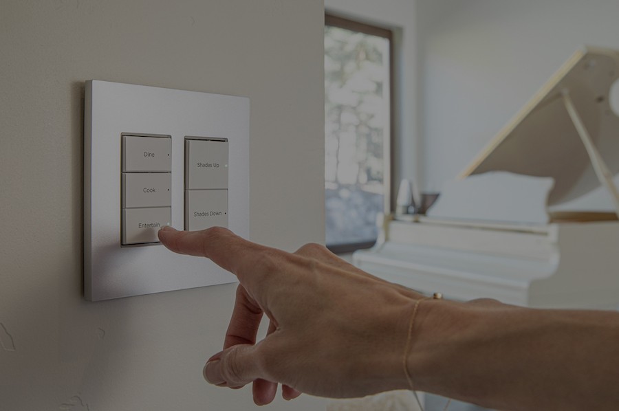 A person's finger presses a Control4 wireless keypad in a Park City, Utah, home.