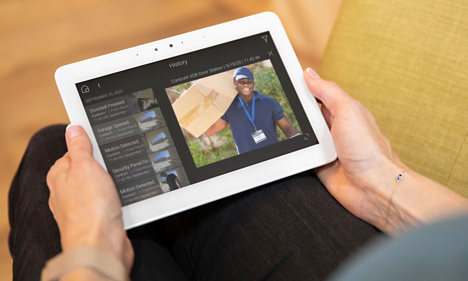 hands holding control4 touch panel 